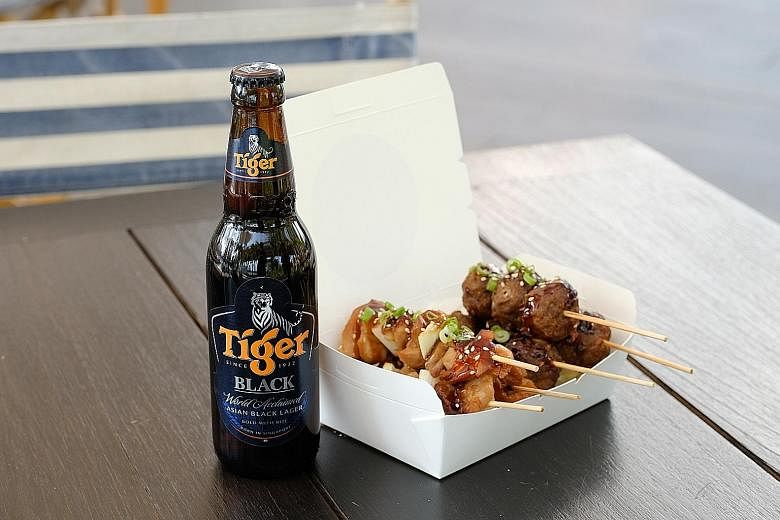 Tiger Black beer with yakitori from gourmet catering company Shiso (above left) and German beer Benediktiner Weissbier with a cheeseburger from American restaurant Handlebar (above right) at Beerfest.