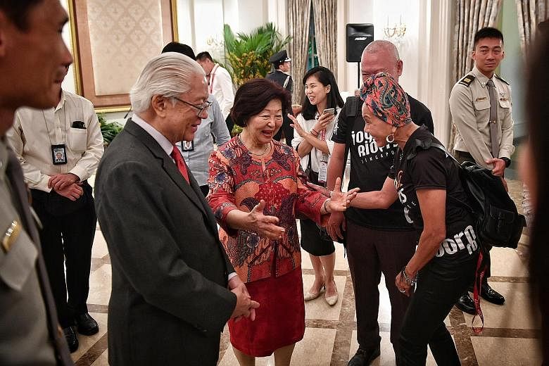 President Tony Tan Keng Yam and Mrs Mary Tan greeting Joyriders founder Joyce Leong at the Istana yesterday. The occasion was a tea reception hosted by the President to thank the organisers and participants of this year's National Day Parade. Recreat