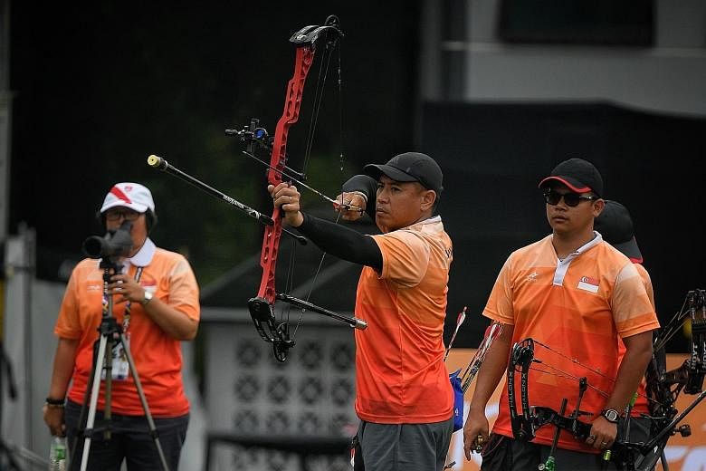 Alan Lee shooting en route to the team compound silver in archery yesterday. It was Singapore's first medal at these SEA Games.