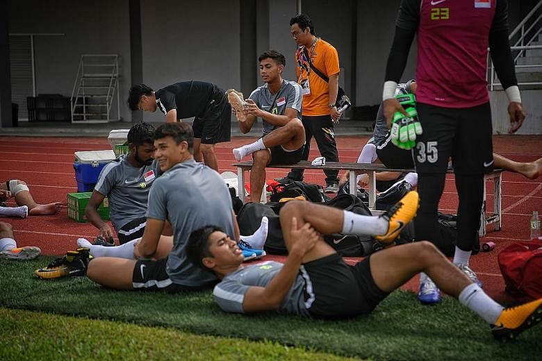 Adam Swandi (on bench) at yesterday's training. The forward says he has recovered fully from the damaged ankle ligament that almost ruled him out of the SEA Games.