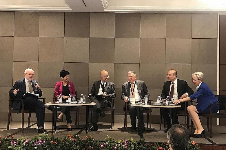 At the SMU-TA Centre for Excellence in Taxation conference yesterday were (from left) Professor Jeffrey Owens, chairman of the centre's technical advisory panel; Ms Indranee Rajah; Mr Chris Woo of PwC Singapore; Prof David Rosenbloom, member of the a