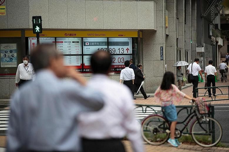 A stock quotation board in Tokyo. A 4 per cent annualised surge in Japanese GDP in the second quarter put the nation at the top of the growth table among the Group of Seven industrial economies.
