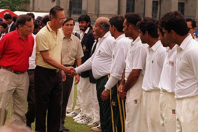 Mr Joe Grimberg (in red) introducing then PM Goh Chok Tong to the Pakistan cricket team manager in 2005, at the Pakistan vs India match at the Singapore Cricket Club.