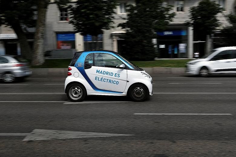 Madrid's city council allows electric vehicles to circulate in restricted zones and park almost anywhere for free. The words on the door reads, "Madrid is electric".