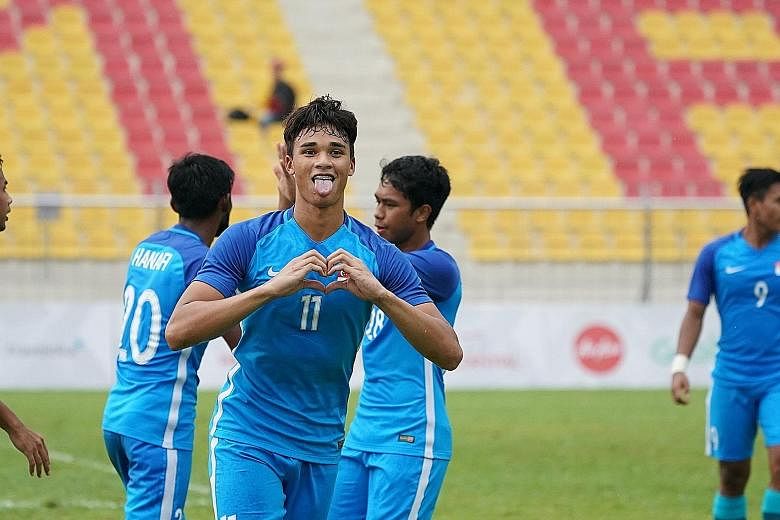 Ikhsan Fandi celebrating his penalty-kick goal to put Singapore 2-0 up against Laos in their Group A match yesterday.