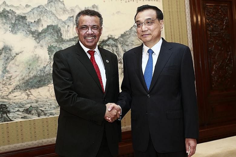 Dr Tedros Adhanom, the director-general of WHO, with Chinese Premier Li Keqiang at a meeting in Beijing yesterday. Dr Adhanom has hailed the Chinese-led health initiative as visionary.