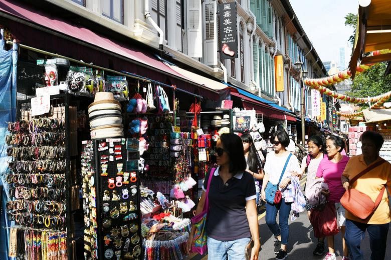 Visitors browsing in Chinatown. The Asean-EU Comprehensive Air Transport Agreement promises to increase aviation links benefiting commerce and tourism, says the writer.