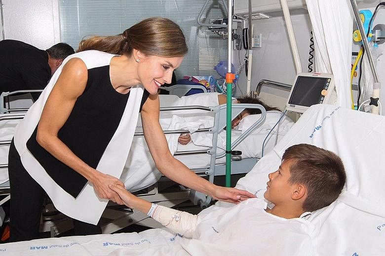 Spain's King Felipe VI, and Queen Letizia have been visiting the Barcelona attack victims, some of them young children. At the Hospital del Mar yesterday, Queen Letizia (above) comforted victims recovering from various injuries with a smile and reass