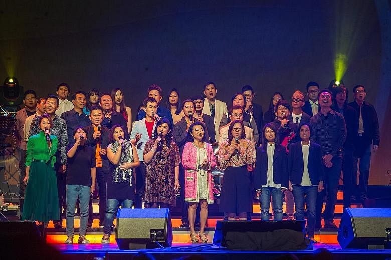 A group performance (above) at the Xinyao 35 Reunion Concert at The Star Theatre last Saturday; veteran songwriter Ng King Kang and singer-songwriter Roy Loi at the concert.