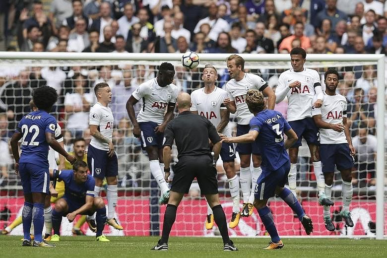 Chelsea's Marcos Alonso curling his free kick over the Tottenham players for the opening goal in their Premier League clash yesterday.