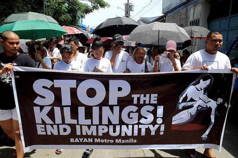 Relatives and loved ones of drug-war victim Leover Miranda, 39, calling for a stop to President Rodrigo Duterte's ruthless campaign during a funeral march in metro Manila yesterday.