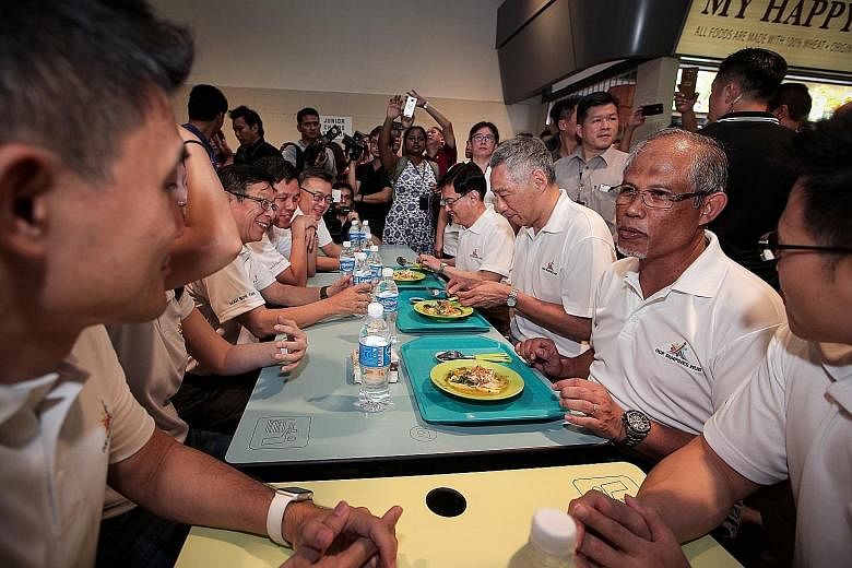 Prime Minister Lee Hsien Loong eating soto ayam with ministers Heng Swee Keat and Masagos Zulkifli at a community event in Tampines earlier this month. With them are minister Chan Chun Sing and other MPs. PM Lee urged Singaporeans to opt for healthie