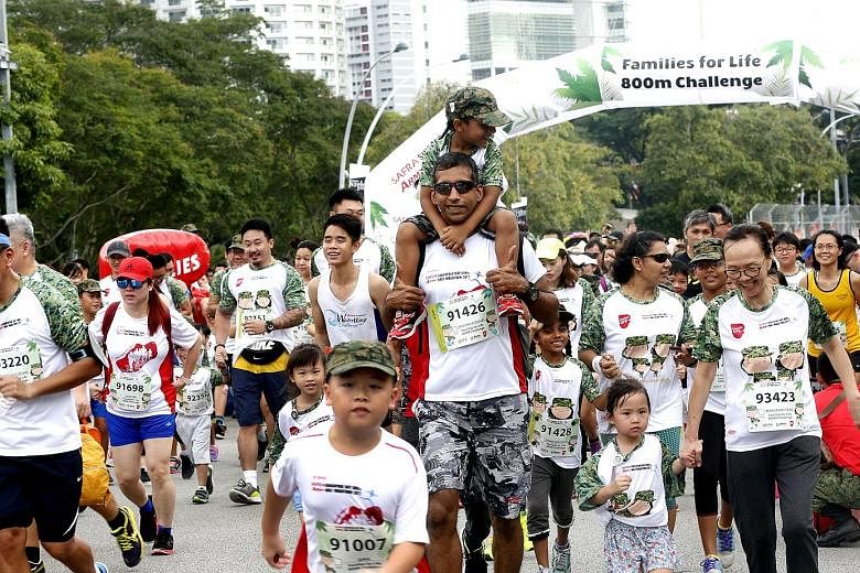 The Families for Life 800m Challenge (above) saw parents and children running together. Participants at yesterday's Safra Singapore Bay Run and Army Half Marathon also got to interact with the event mascots.