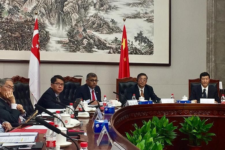 Singapore Chief Justice Sundaresh Menon (third from left) and Chinese Supreme People's Court president Zhou Qiang (fourth from left) at the round-table talk yesterday. With them are (from left) Singapore's Judge of Appeal Chao Hick Tin and Ambassador