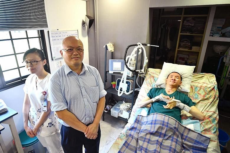 Dr Chan Yeow, director of TTSH's Home Ventilation and Respiratory Support Service, and senior staff nurse Ni Bin with patient Jason Ong, who suffered a spinal cord injury 14 years ago. The portable ventilator in Mr Ong's bedroom at his home in Telok 