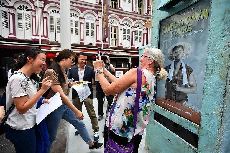 An Australian tourist taking a selfie in April with a character in the digital screen, part of a pilot initiative by STB to promote Chinatown. More than a million Australians visited Singapore last year.