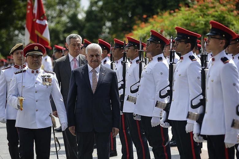 Singapore Prime Minister Lee Hsien Loong and Turkish Prime Minister Binali Yildirim at the official welcome ceremony at the Istana yesterday.