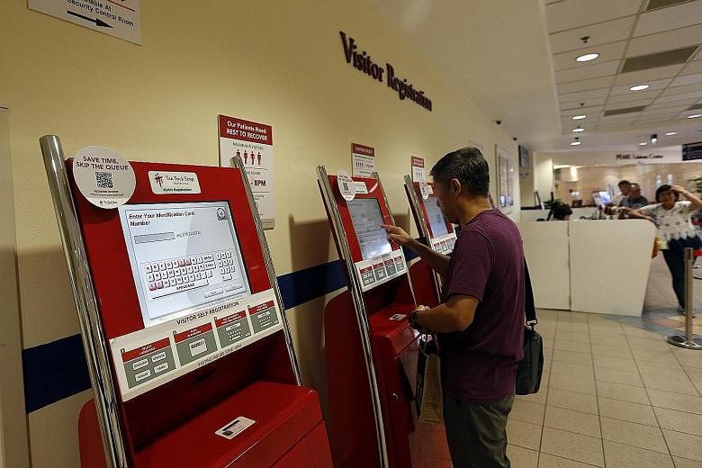 Left: A visitor using an automated booth at Tan Tock Seng Hospital. Visitors register using their identity cards to gain access to the wards. Below left: The system comes complete with gantries. All six acute general hospitals in Singapore will have 