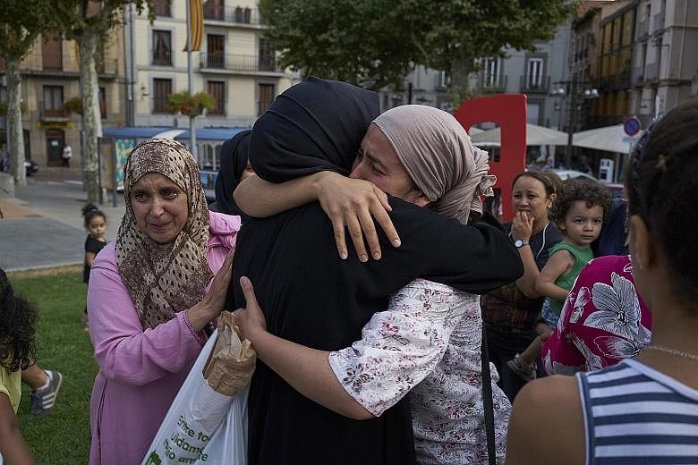 Relatives of the men suspected to be behind the Barcelona and Cambrils attacks gathering with other Muslims in the main square of Ripoll, a town close to the French border, last Saturday. Younes Abouyaaqoub's mother Hannou Ghanimi had appealed on the week