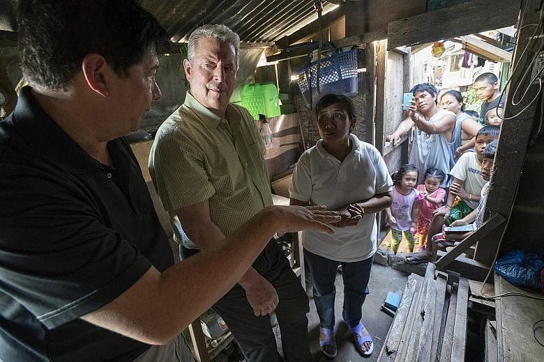 Former United States vice-president Al Gore (second from left) meeting hurricane survivors in Tacloban in the Philippines after Typhoon Haiyan, in a scene from An Inconvenient Sequel: Truth To Power, which Jon Shenk co-directed.