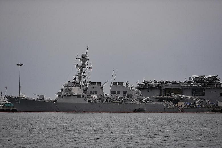The USS John S. McCain at Changi Naval Base yesterday. The US warship is berthed in Singapore after it sustained serious damage after colliding with an oil tanker early on Monday.