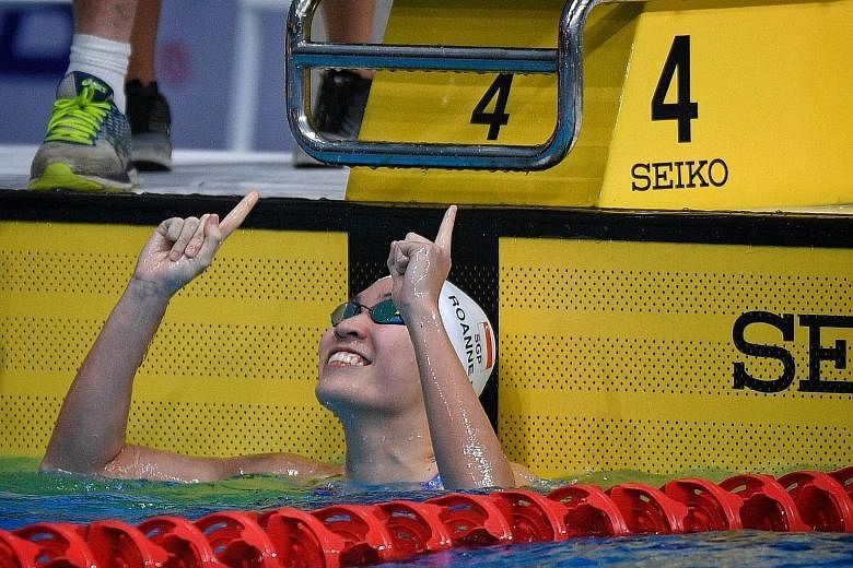 Singapore's Roanne Ho points skywards after winning the 50m breaststroke gold in a national and Games record time of 31.29sec.