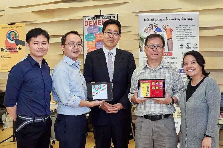 Mr Chew Khoon Hong (second from right) and MindWorks developers (from left) Dr Chee Chew Sim, Mr Sam Sim, Professor Ryuta Kawashima and Ms Shereen Pong showing the free Android games. Mr Chew is one of the seniors who tested the brain-training games,