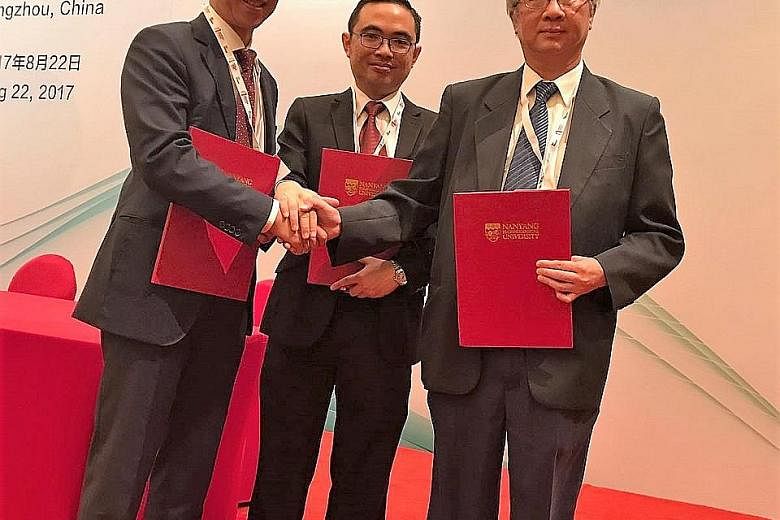 Among those who inked agreements at the eighth Singapore- Guangdong Collaboration Council meeting in Guangzhou yesterday were (from left) TechBridge Ventures' chairman, Dr Lim Jui, and its chief executive, Mr Ho Voon Yee, and Mr Leung Wah Kan, chief 