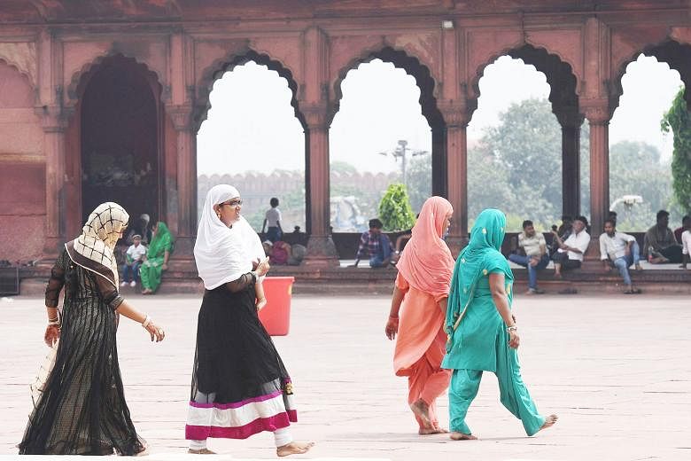 Indian Muslim women on their way to the Jama Masjid in New Delhi yesterday. The Supreme Court ruling ends a long tradition that many Muslim women had fiercely opposed.