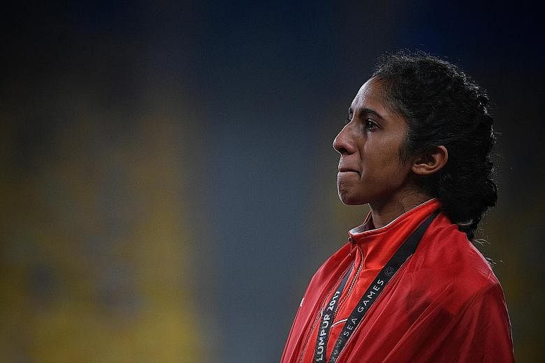 Shanti Pereira holding back tears on the podium after finishing third in the women's 200m final last night.