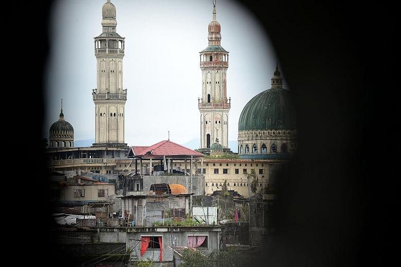 The Philippine army reclaimed Marawi city's grand mosque, seen from a sniper's position, on Thursday.