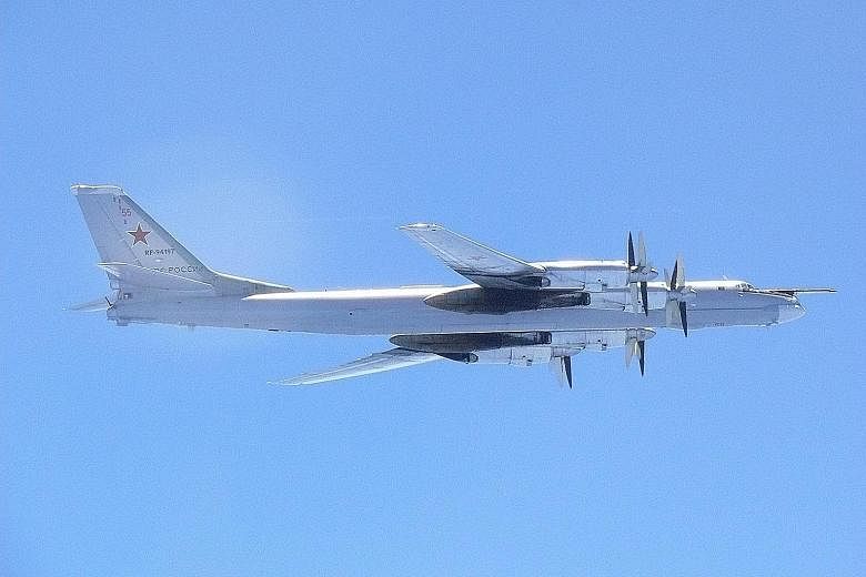 A Russian Tupolev-95MS bomber flying near the southern part of Japan on Wednesday in this handout picture taken by Japan's Air Self-Defence Force. The Russian mission flew over the Pacific Ocean, the Sea of Japan/East Sea, the Yellow Sea and the East