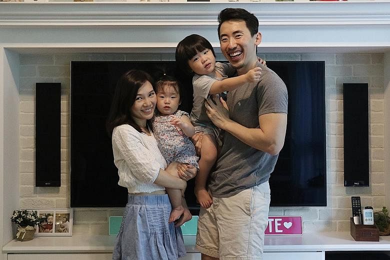 Blue tiles, to replicate the hues of the sky and the ocean, as well as sand-textured walls re-create the Maldivian beach villa vibe in the master bathroom (above). Home owners Kenneth Tan and Jael Tan (both left) with their children, Odette, one, and