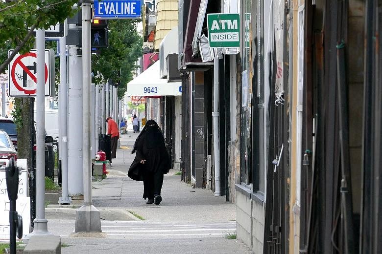 Burqa-clad women and men with Islamic caps are common sights in Hamtramck. Its biggest communities are from Yemen and Bangladesh. Its once-dominant Polish community is down to 10 per cent of the population. From top: Mr Greg Kowalski, chairman of the