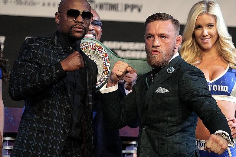 Boxer Floyd Mayweather Jr (far left) and mixed martial arts star Conor McGregor pose during a media press conference at the MGM Grand Las Vegas.