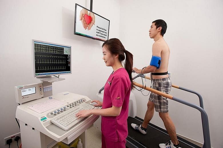 A patient undergoing an exercise stress test at the National Heart Centre Singapore. Not only do more men develop cardiovascular diseases than women, but women here also develop the diseases about 10 years later than men.