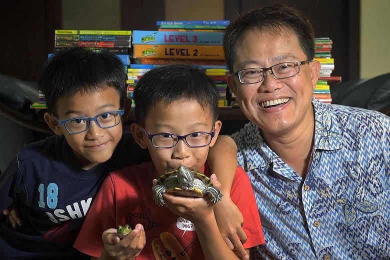 Kayden, nine; Kieran, with his pet turtle and pet frog; and their father Alvin Lee, 52. Said Kieran: "I just want an hour of homework. Otherwise, it piles up and when I look at the stack of work, I feel very stressed out." Eleven-year-old Kieran Lee 