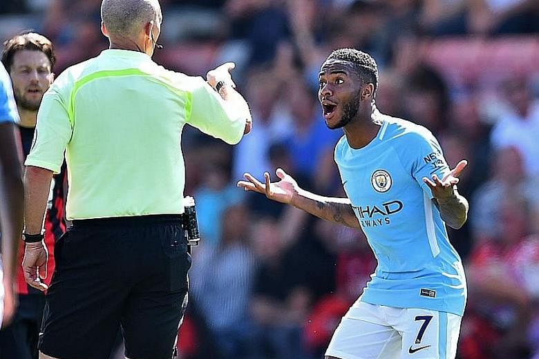 Manchester City's Raheem Sterling is bewildered after receiving a second yellow card from referee Mike Dean for going into the crowd to celebrate his 97th-minute goal yesterday.