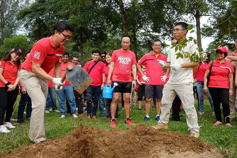 Insurer Great Eastern marked its 109th birthday by having 109 staff, distribution representatives and executives plant 50 endangered native trees at East Coast Park yesterday. They include Mr Colin Chan (with hoe), group marketing managing director; 