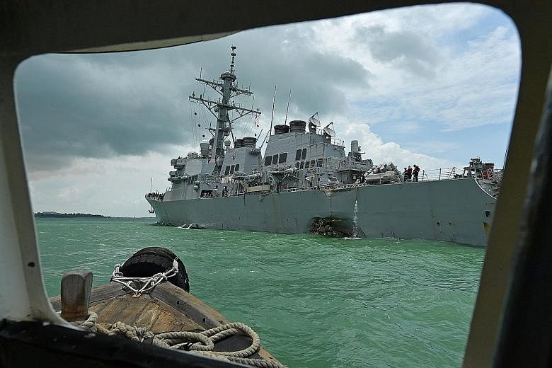 The US Navy destroyer USS John S. McCain with the damage to its port side last Monday. It was involved in a collision with oil tanker Alnic MC. Five sailors were injured and another 10 went missing. Two bodies have been found.