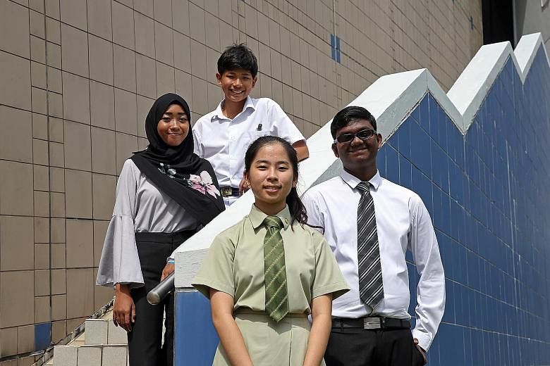 Hard work pays for (from left) Zuhairiena Zakaria, 17; Hans Gerhard Van Huizen, 13; Diana Chia, 17; and T. Pravin, 17. They are among 743 PSLE, GCE N- and O-level students who received book vouchers.