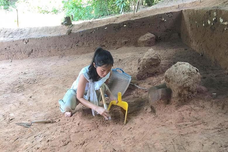 Above: Ms Khoo working in an excavation pit. Left: A close-up of the Buddha statue with a naga hood.