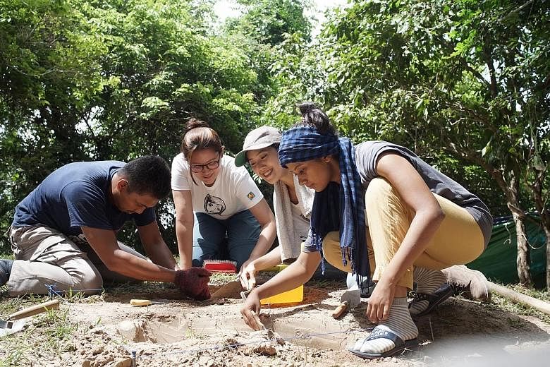 Above: Singaporean Natalie Khoo (second from right) and her teammates (from left) Indonesian Amir Husni, Filipina Anne Marie Valera and Indian Shaashi Ahlawat had been digging on a sloping mound when the statues started appearing. Left: The artefacts