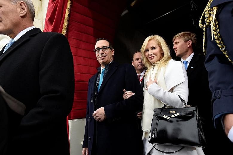 US Treasury Secretary Steven Mnuchin and actress Louise Linton - the couple were married on June 24 this year - at the presidential Inauguration of Mr Donald Trump in January. Amid the outrage sparked by his wife, Mr Mnuchin now faces the challenge o