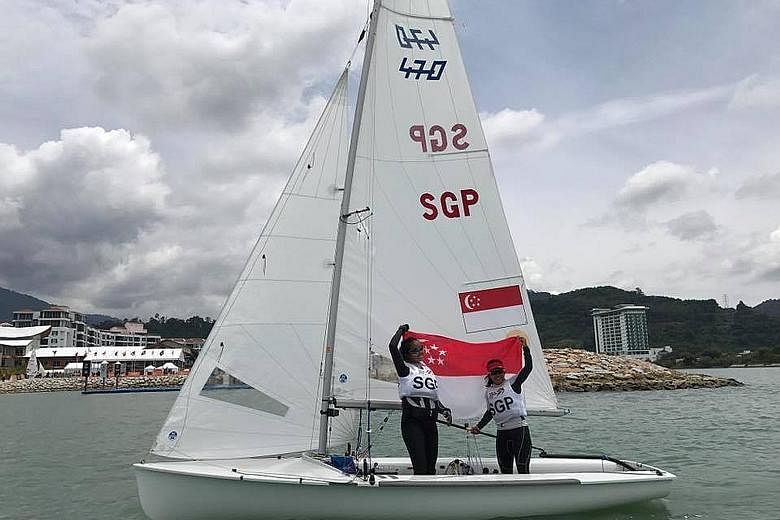 Sailors Cheryl Teo (left) and Yukie Yokoyama rejoice after winning the women's 470 title in Langkawi. Their win took hours to sink in, as they were underdogs against Malaysia.