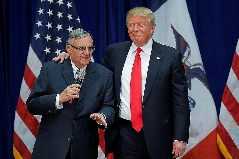 Mr Donald Trump with former sheriff Joe Arpaio during a campaign rally in January last year. Arpaio endorsed Mr Trump's candidacy and the two men found common ground on illegal immigration.