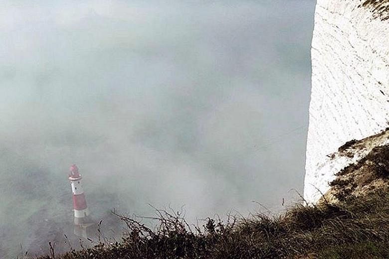 A "mist" surrounding Beachy Head Lighthouse along the southern English coast, near Eastbourne, seen on Sunday in this picture obtained from social media. Emergency services evacuated a beach in Sussex after people reported pain and a stinging feeling