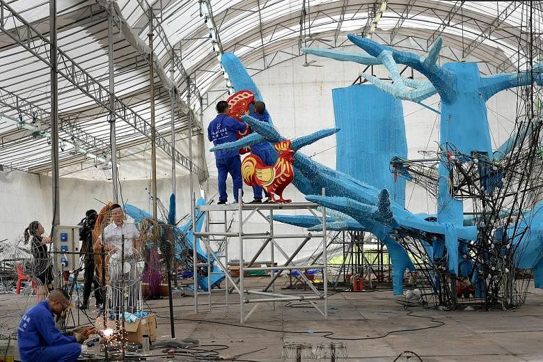 Craftsmen from Sichuan hanging one of 112 animal lanterns that will adorn a "family tree" which measures 12m high by 10m wide. This year's Mid-Autumn Festival celebrations will feature more than 1,000 lanterns and more than 10,000 LED light bulbs. Th
