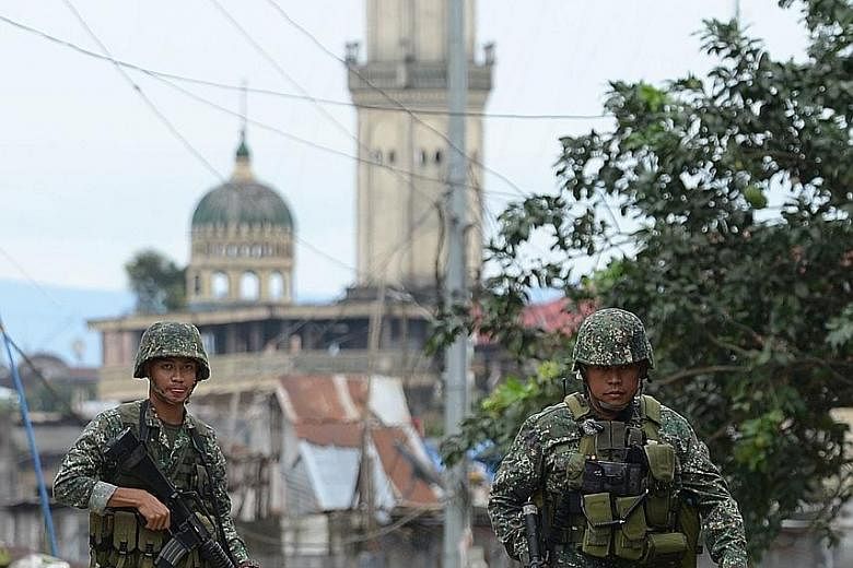Philippine forces patrolling a deserted street in Marawi late last month. The battle is seeing its final days as troops accomplished a series of recent victories.