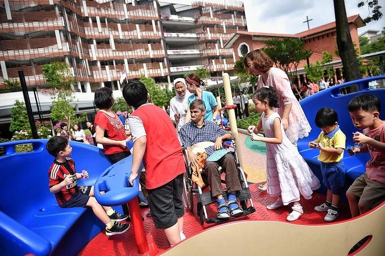 The inter-generational playground has a merry-go-round with wheel-lock features, allowing both children and seniors to ride together.
